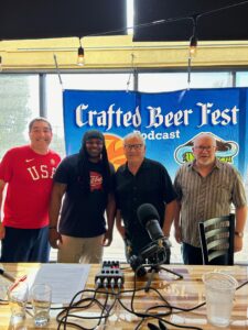 Marc Roland & Jim Seeks talk to crafted Beerfest podcast standing in front the crafted banner