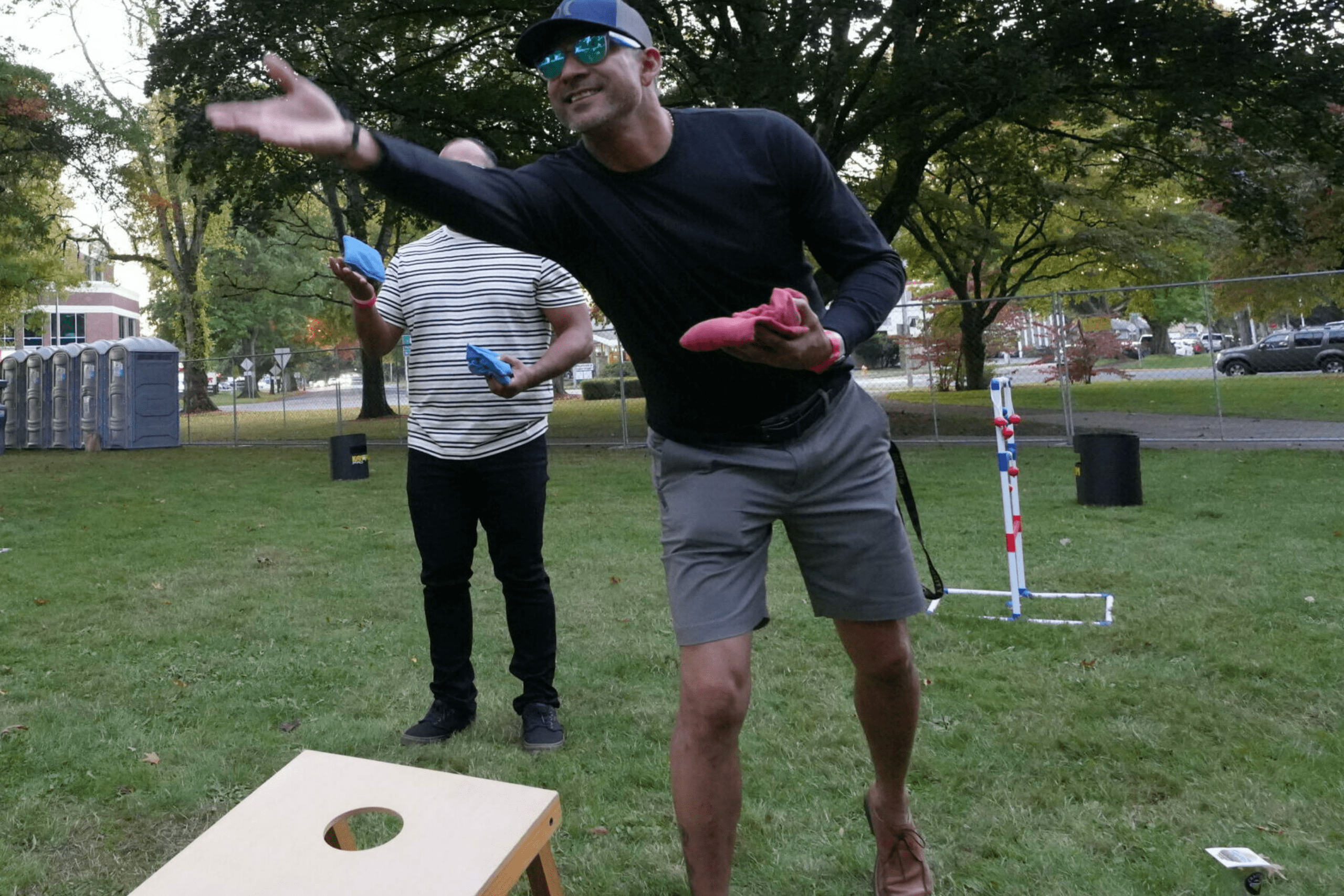 guys playing cornhole at crafted brew festival in RA Long Park